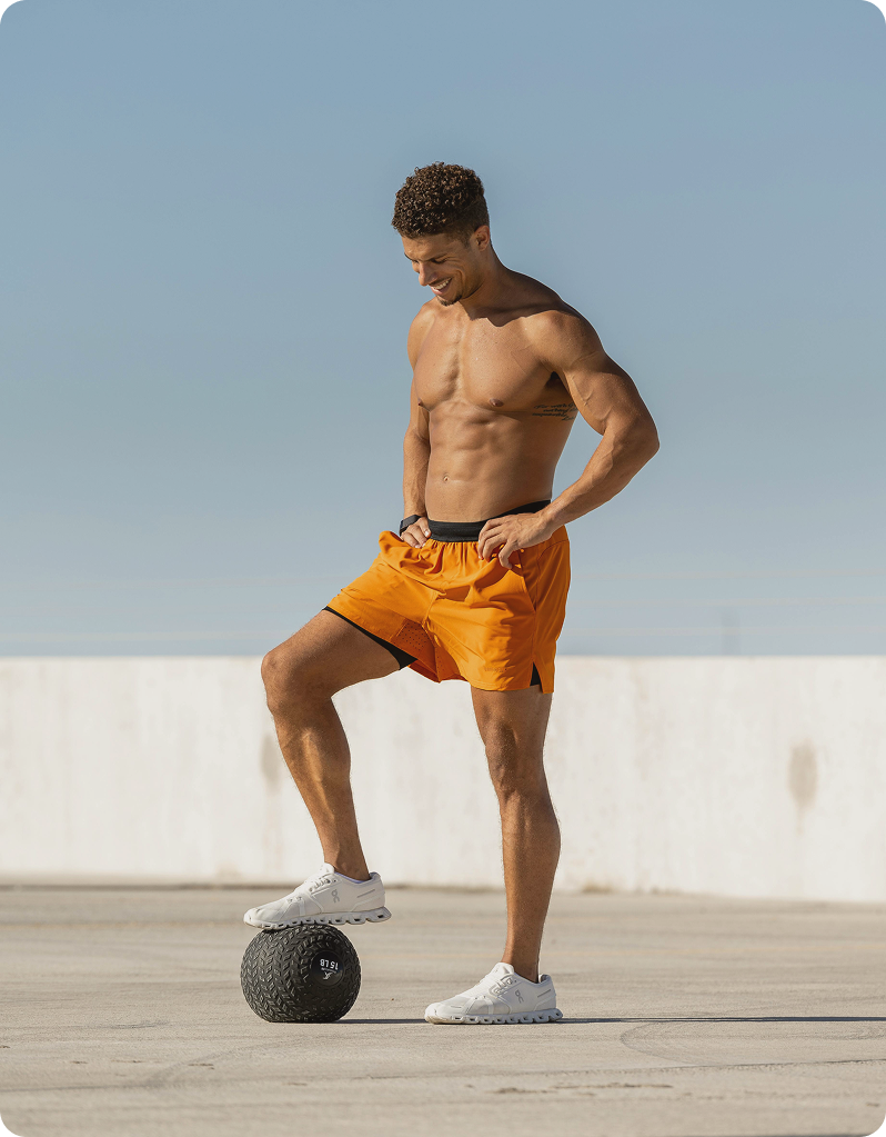 Man standing mid-workout with a weighted ball, reflecting structured training and lifestyle support connected to Tirzepatide GLP-1 in West Edmonton, AB at Gameday Men’s Health.