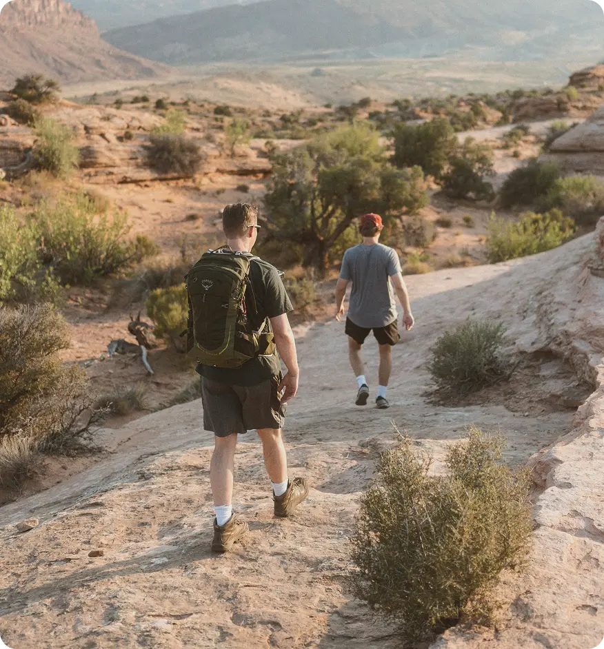 Two men hiking in the mountains, representing endurance, recovery, and active lifestyle goals supported by Tri-Amino Acid injections in Friendswood, TX.