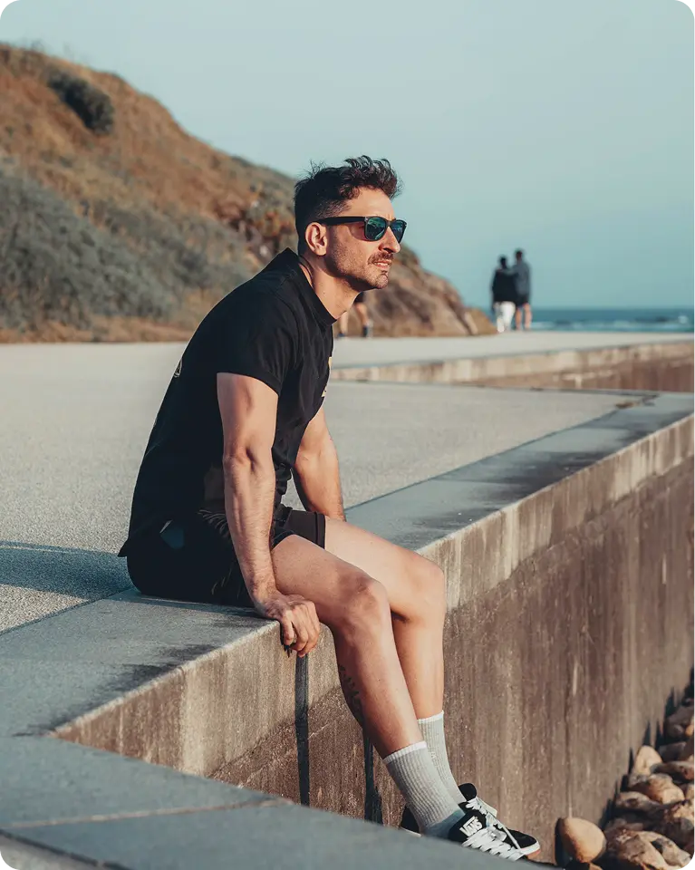 Man resting near the water while watching the sunset, capturing a calm outdoor scene aligned with wellness support from Oral BPC-157 in West Edmonton, AB.