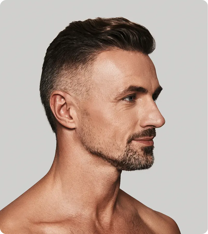Confident man with fuller-looking hair, symbolizing hair regrowth support provided through Minoxidil therapy in Burlington, NC.