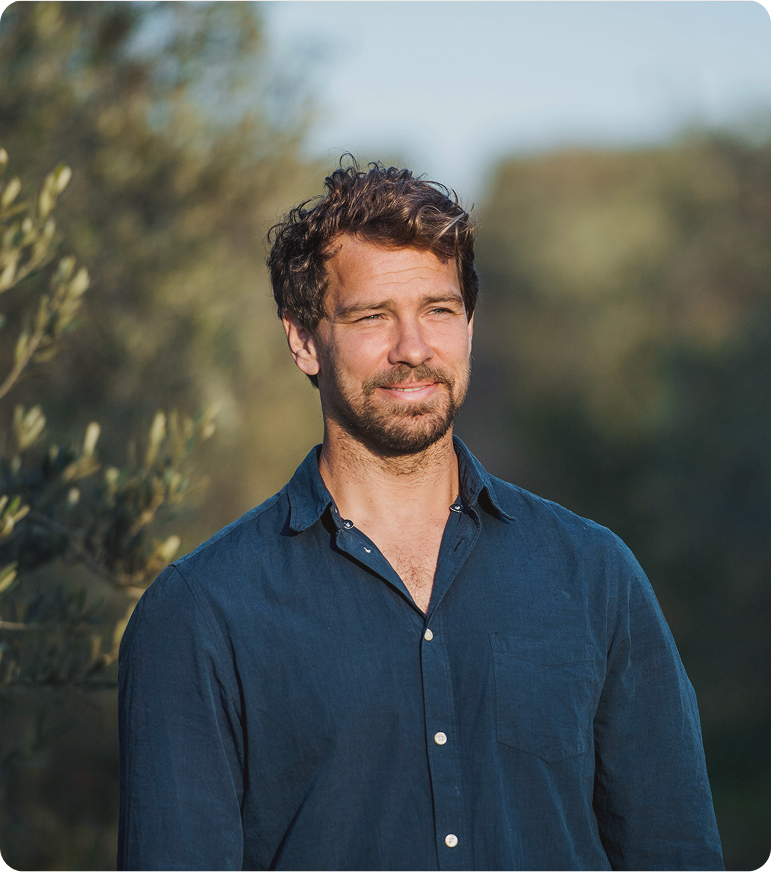 Man walking through a park in reflection, representing balanced hormone health supported by oral TRT treatment in Friendswood, TX.