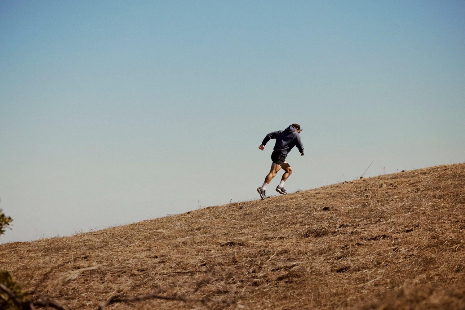 Man running hills outside representing Gameday Men's Health Boulder's Black Friday 2025 sale.