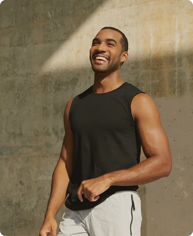 Happy man standing and smiling confidently, reflecting improved awareness and results tracking through Body Composition Scan in Des Moines