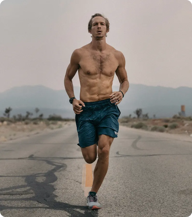 Runner training on a scenic mountain road, symbolizing active lifestyle changes associated with Semaglutide in Des Moines