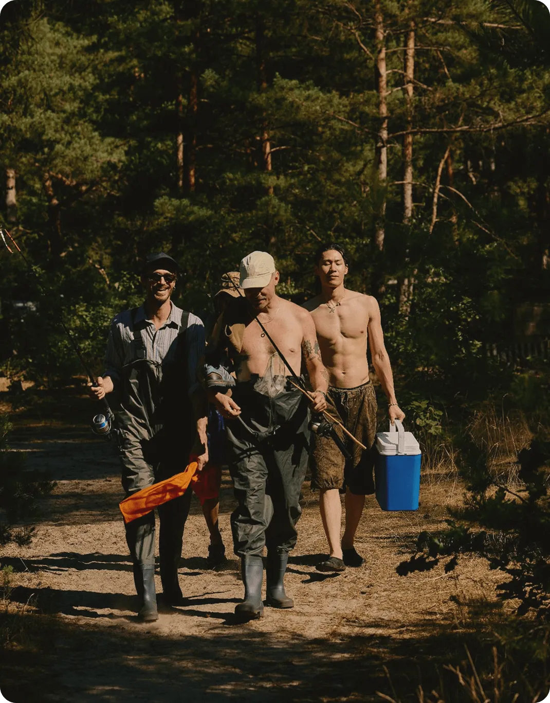Group of fit men walking through a forest with fishing gear, representing energy, strength, and lifestyle benefits connected to Testosterone Cypionate Injections in Des Moines