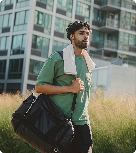Man leaving the gym after a workout session, reflecting recovery and performance support associated with CJC-1295 / Ipamorelin Peptide Injections in {{location_name}} at Gameday Men’s Health {{city}}