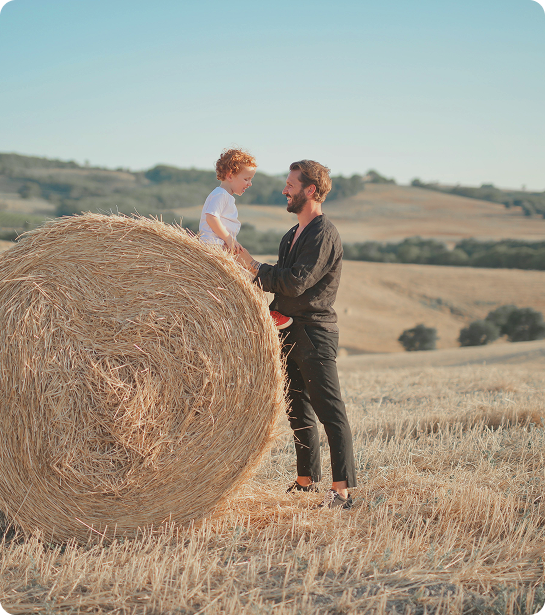 Man spending time with his children outdoors on a field, reflecting energy and family-focused lifestyle supported by KPV Peptide Injections in {{location_name}} at Gameday Men’s Health {{city}}