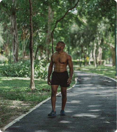 Fit man standing after a run in the park, reflecting endurance, recovery, and active lifestyle supported by Tesamorelin Peptide Injections in {{location_name}} at Gameday Men’s Health {{city}}
