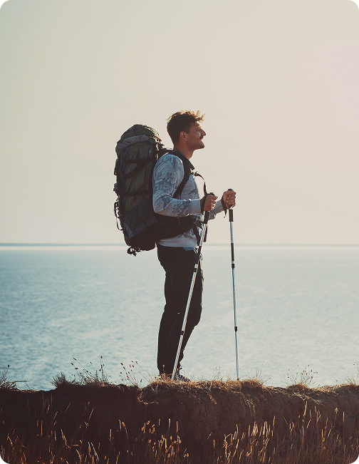 Man standing on top of a mountain after a hike, reflecting recovery, endurance, and performance supported by TB-500 Injections in {{location_name}} at Gameday Men’s Health {{city}}