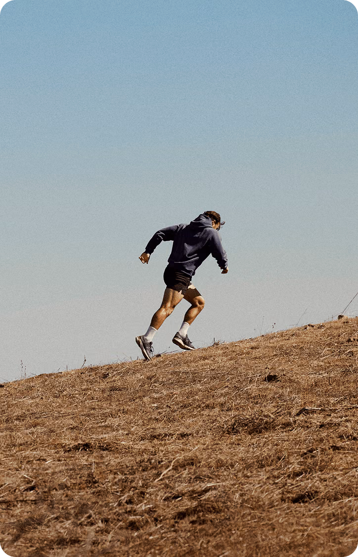 Fit man running uphill, representing natural testosterone support through Clomid and Enclomiphene therapy at Gameday Men’s Health