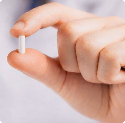 Small testosterone pellets displayed in hand, used for long-acting hormone therapy at Gameday Men’s Health in Elmhurst, Illinois.