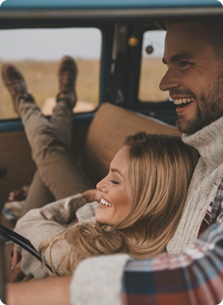 Man and woman sitting together in a car smiling, reflecting everyday confidence supported by Trimix Injections in Mesa