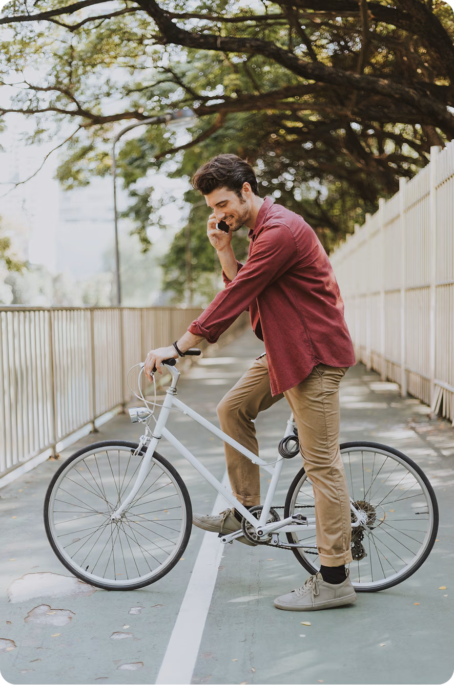 Man resting on a bike during an outdoor ride, symbolizing energy, motivation, and daily performance supported by hormone therapy in Elmhurst, Illinois.