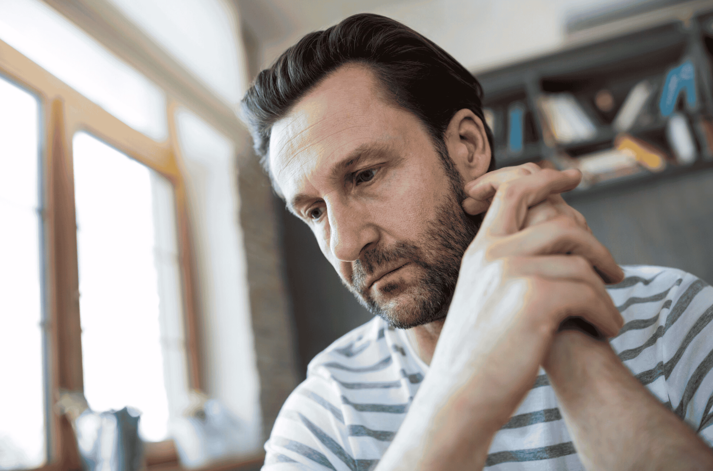Thoughtful man sitting and reflecting, representing concerns and potential side effects associated with minoxidil use
