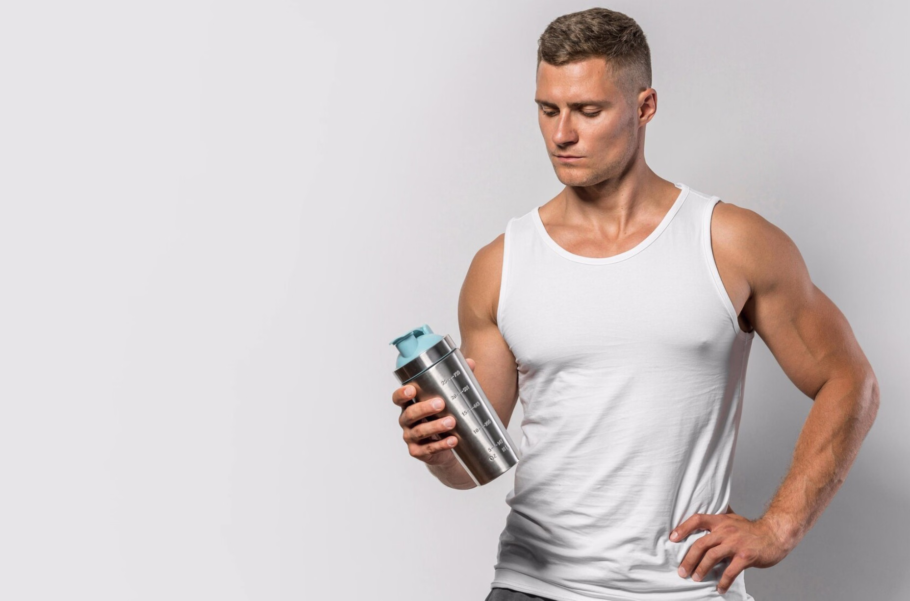 Athletic man holding a protein shaker with creatine, highlighting questions around supplements, fitness, and testosterone support in men.