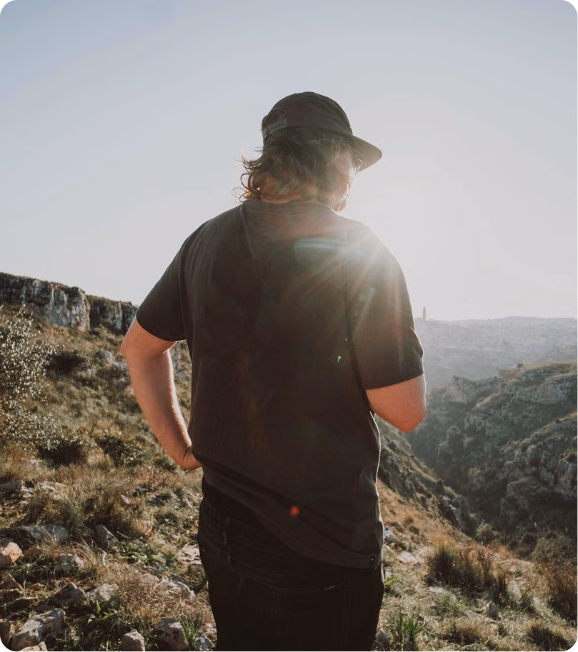Hiker enjoying a mountain trail, symbolizing active recovery and lifestyle balance supported by IV therapy.