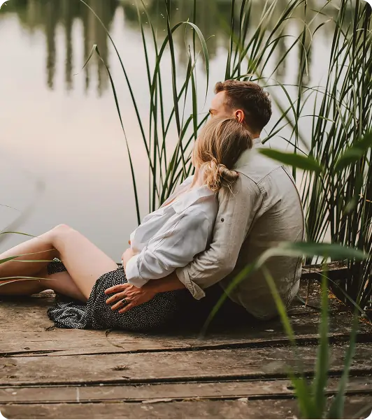 Couple sitting together outdoors.