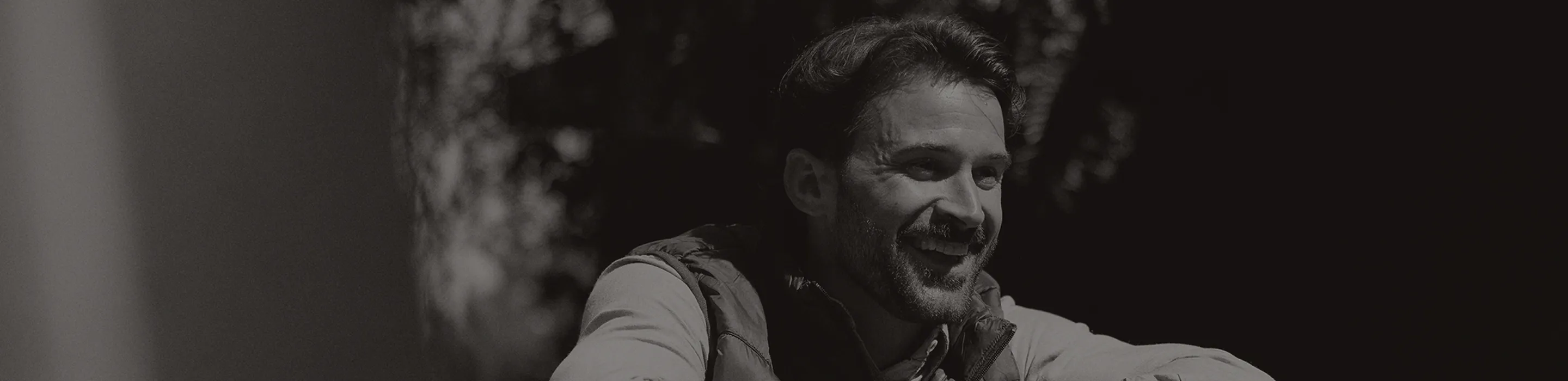 Man smiling outdoors.