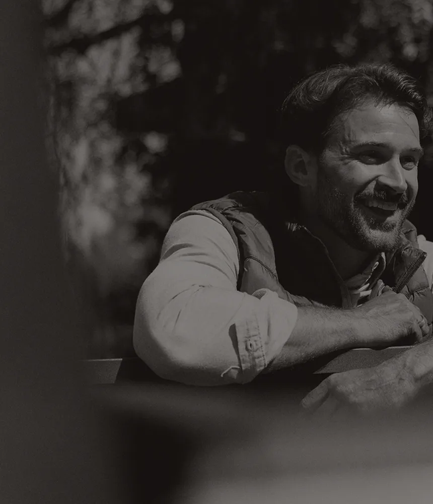 Man smiling outdoors.