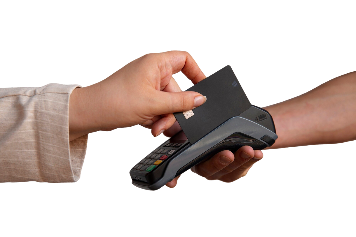 Hand holding black credit card near payment terminal held by another hand for contactless payment.