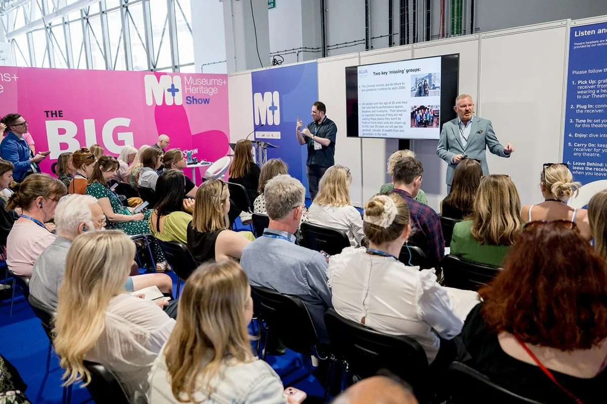 Theatre 1 at the M+H show - blue and pink branding covers the walls