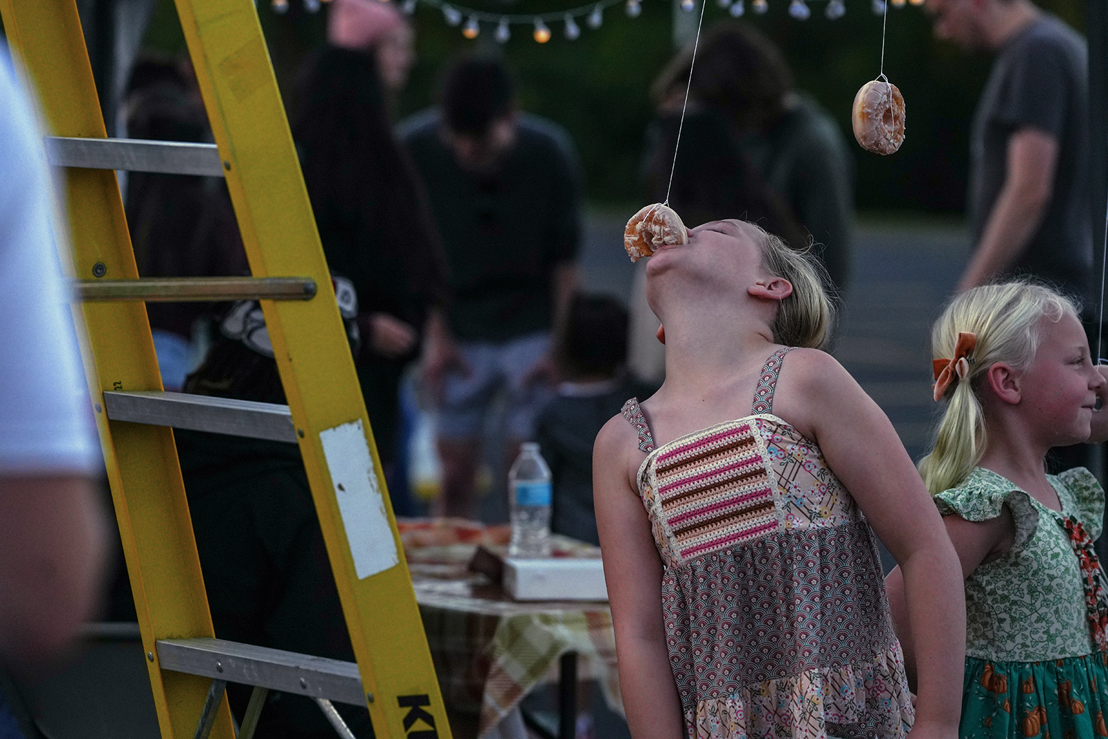 Event photograph of girl eating donut