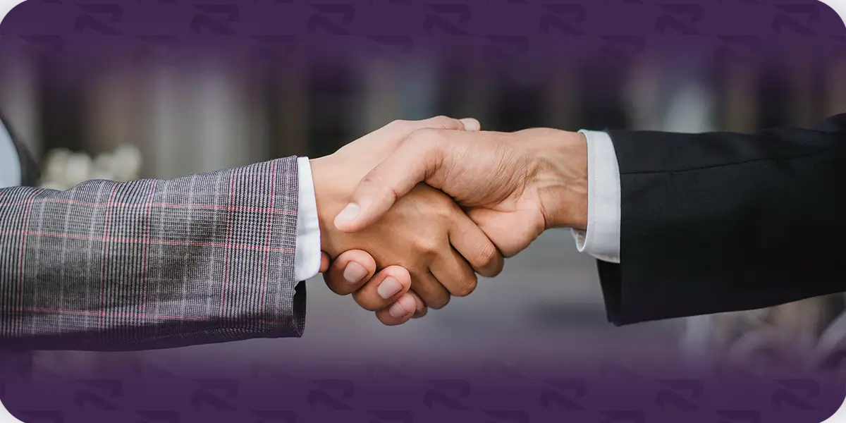 Two people in business attire shaking hands against a purple Rivalane-branded background