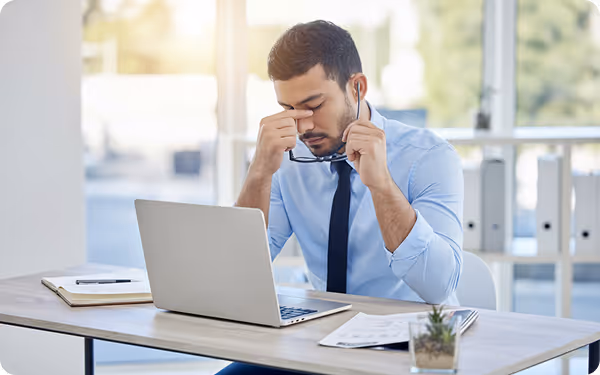 Business professional working on a laptop outdoors on a balcony