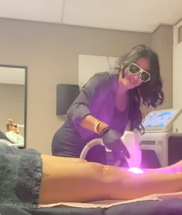 Maryam removing hair witha a laser from her client's legs