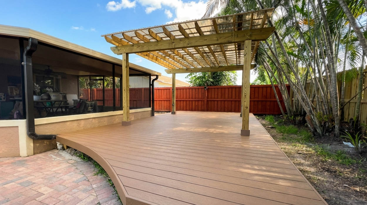Custom composite deck with pergola structure built by licensed deck contractors serving North & South Florida homes.