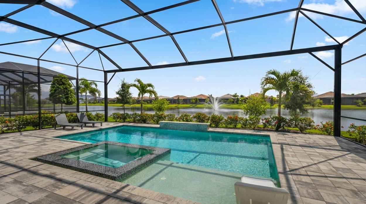 Modern pool screen enclosure overlooking lake views, designed and installed by pool enclosure contractors in Florida.