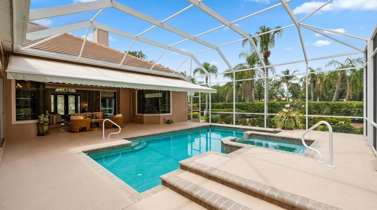 White aluminum pool screen enclosure protecting pool and patio, installed by Florida pool enclosure contractors.