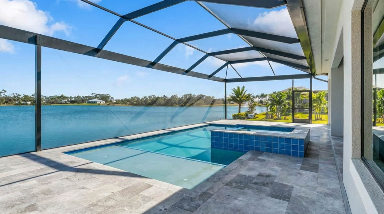Pool screen enclosure with covered living space and ceiling fans, built by professional builders in North Florida.