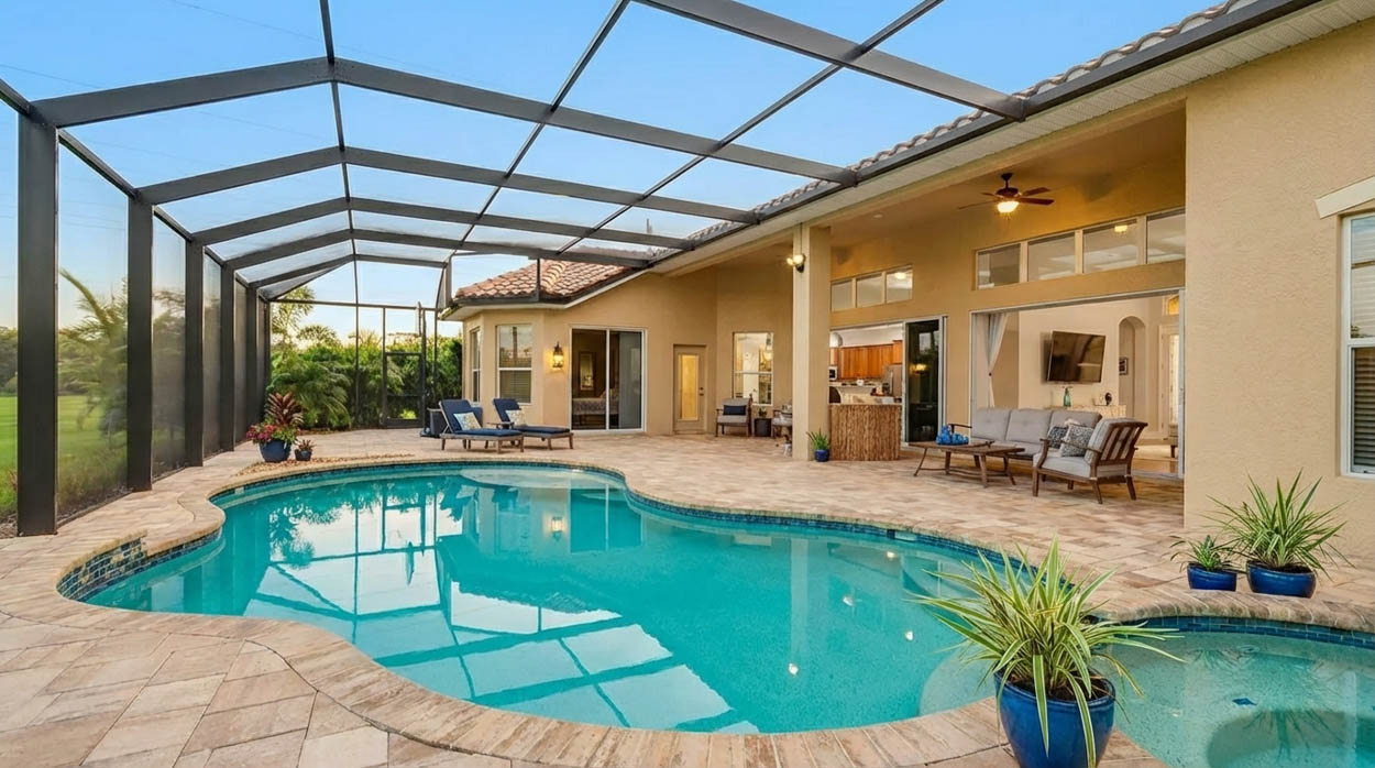 Lakefront pool screen enclosure designed for airflow and views by licensed pool enclosure builders in Florida.