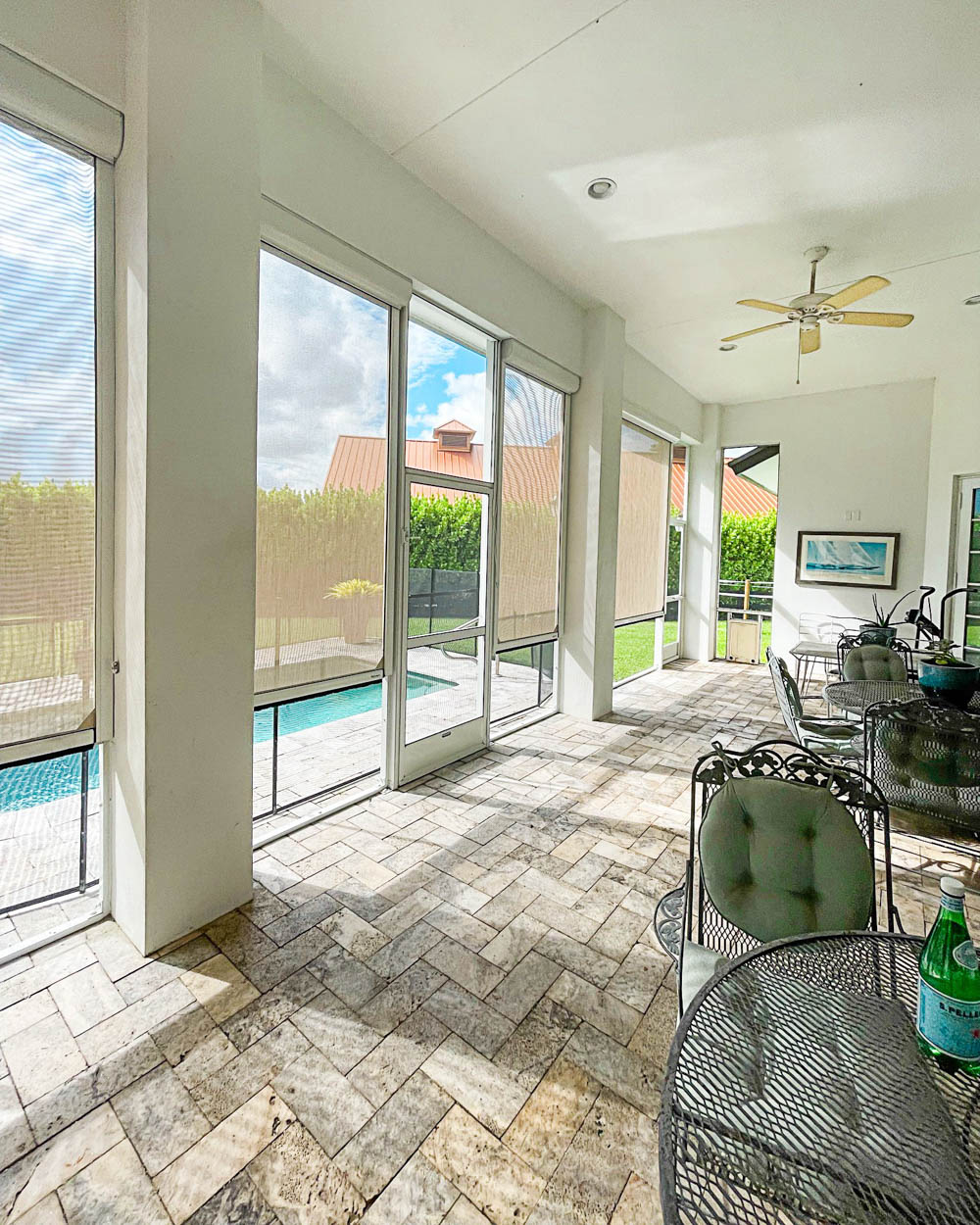 High-quality motorized retractable screens installed on a residential lanai, providing shade, privacy, and insect protection for outdoor living spaces in Florida.