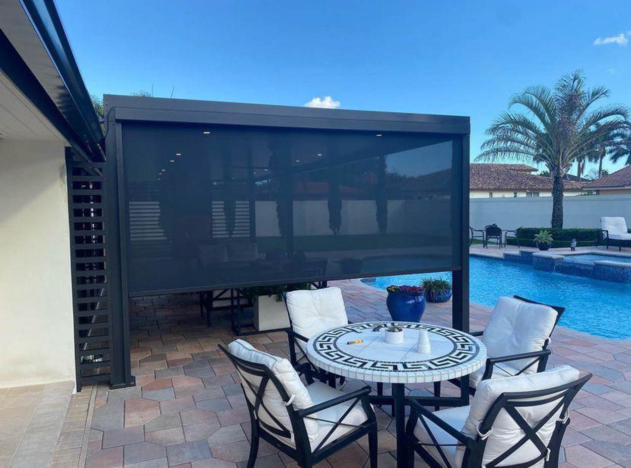 Professionally installed motorized patio screen system providing insect protection, shade, and enhanced comfort for South Florida outdoor living spaces.