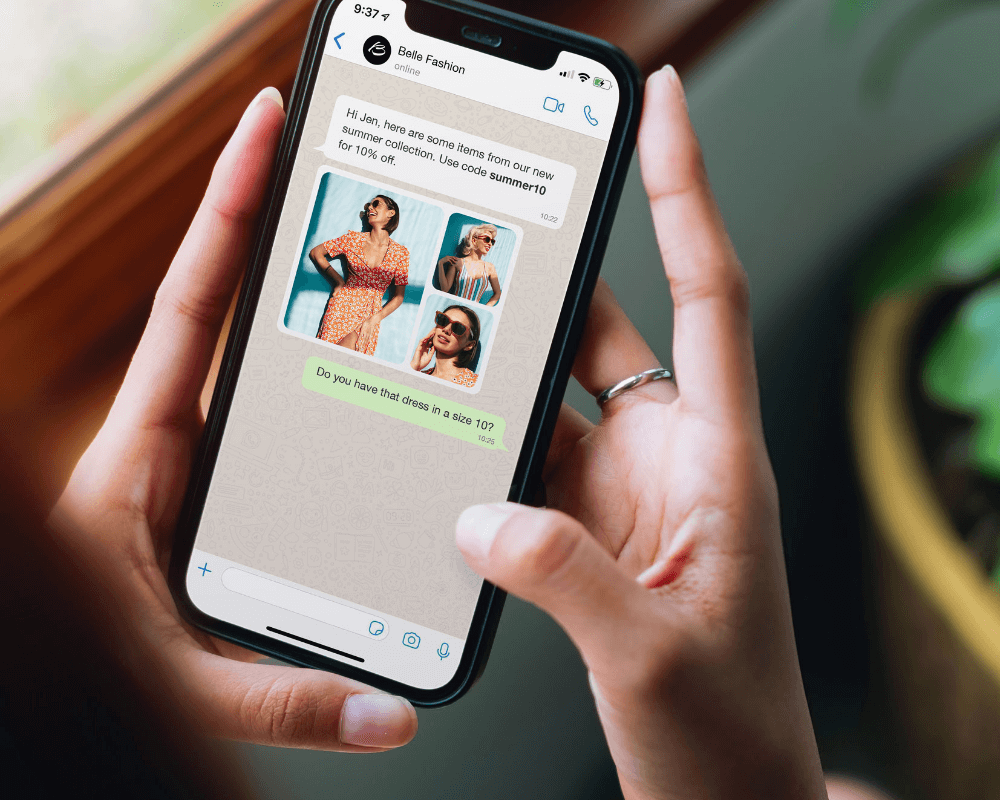 Hand holding a smartphone displaying a WhatsApp conversation where a fashion brand shares images of summer dresses with a discount code, and the user asks about dress size 10.