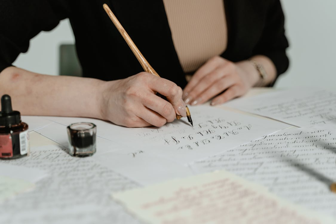 : a graphic designer checking different script fonts for a logo