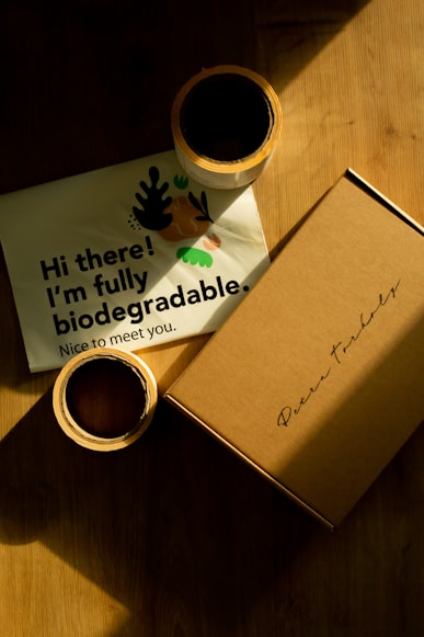 Two Rolls of Tape Beside a Brown Box and a Message Indicating that the Box Might be Biodegradable