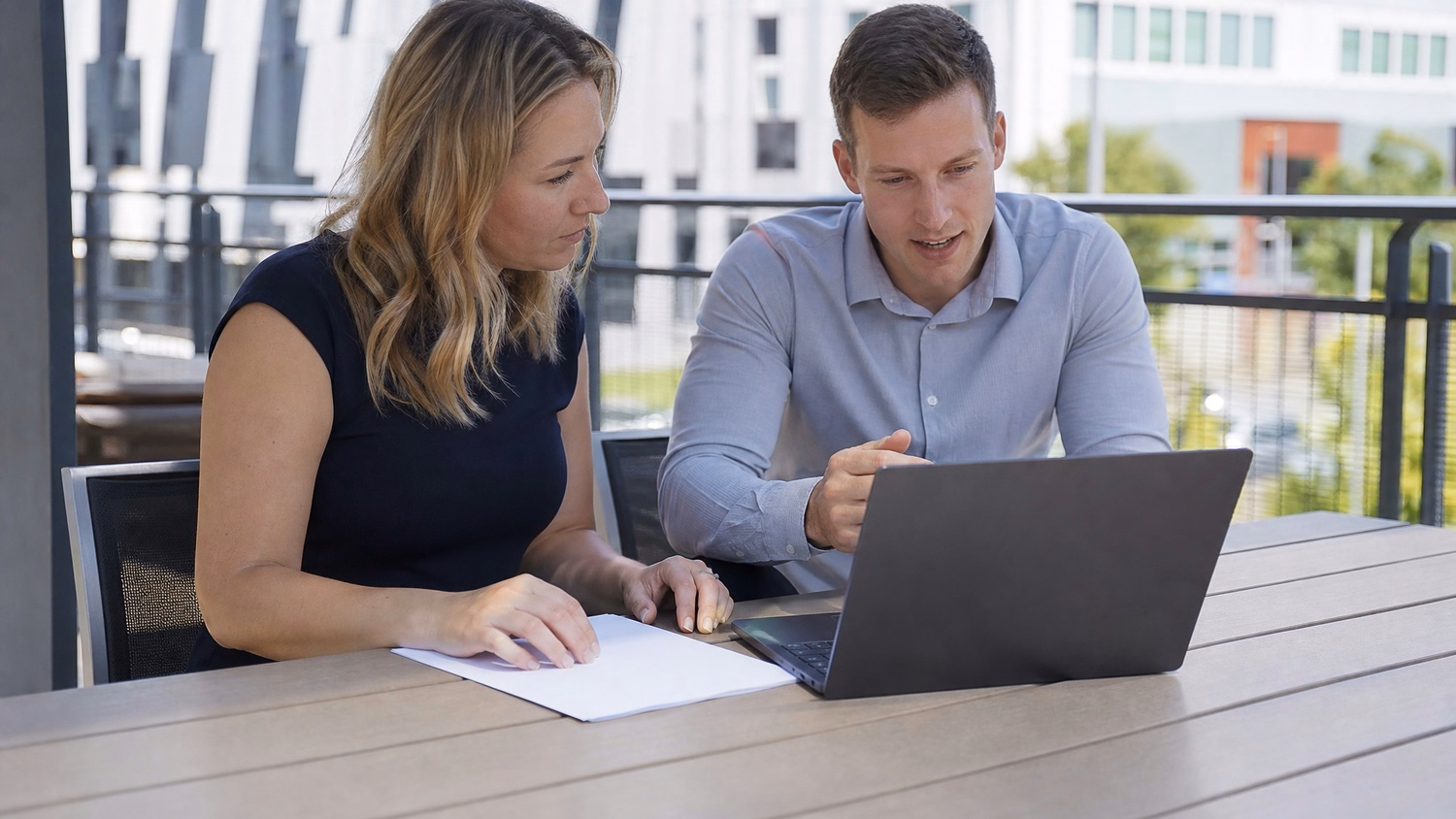 OUTDOOR TERRACE An IT professional one or two people working at a table on a