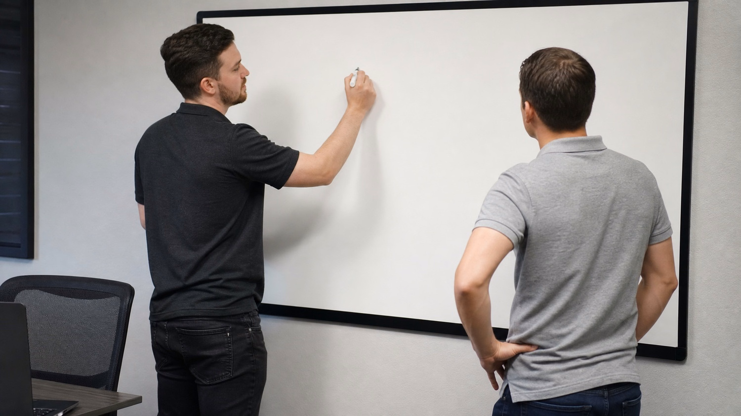 WHITEBOARD SESSION An IT professional one or two people standing at a whiteb
