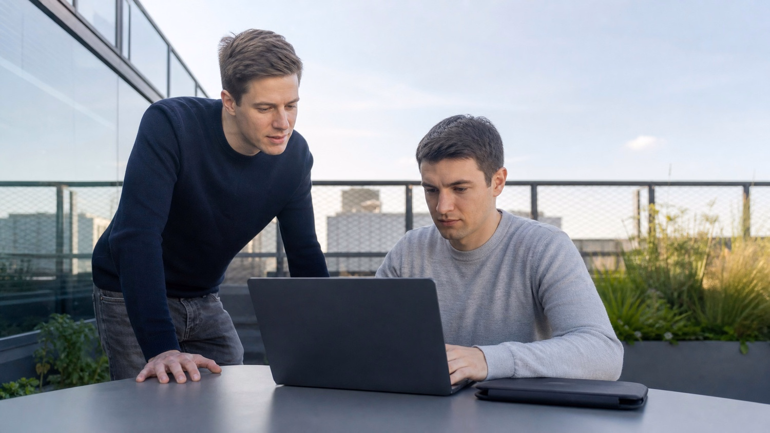 OUTDOOR TERRACE An IT professional one or two people working at a table on a