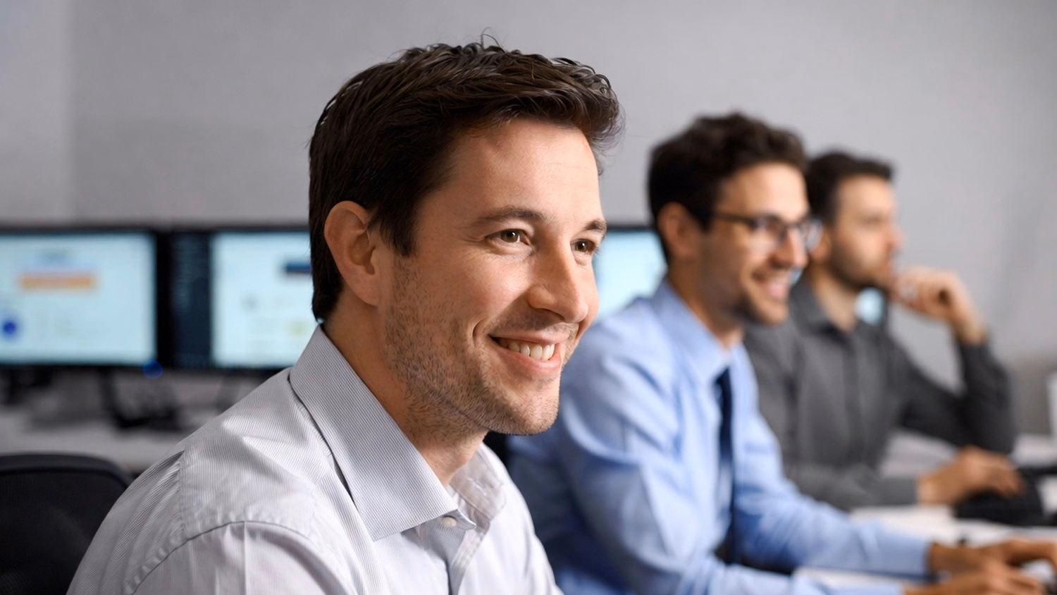 IT consultant analyzes cloud services dashboard on monitor