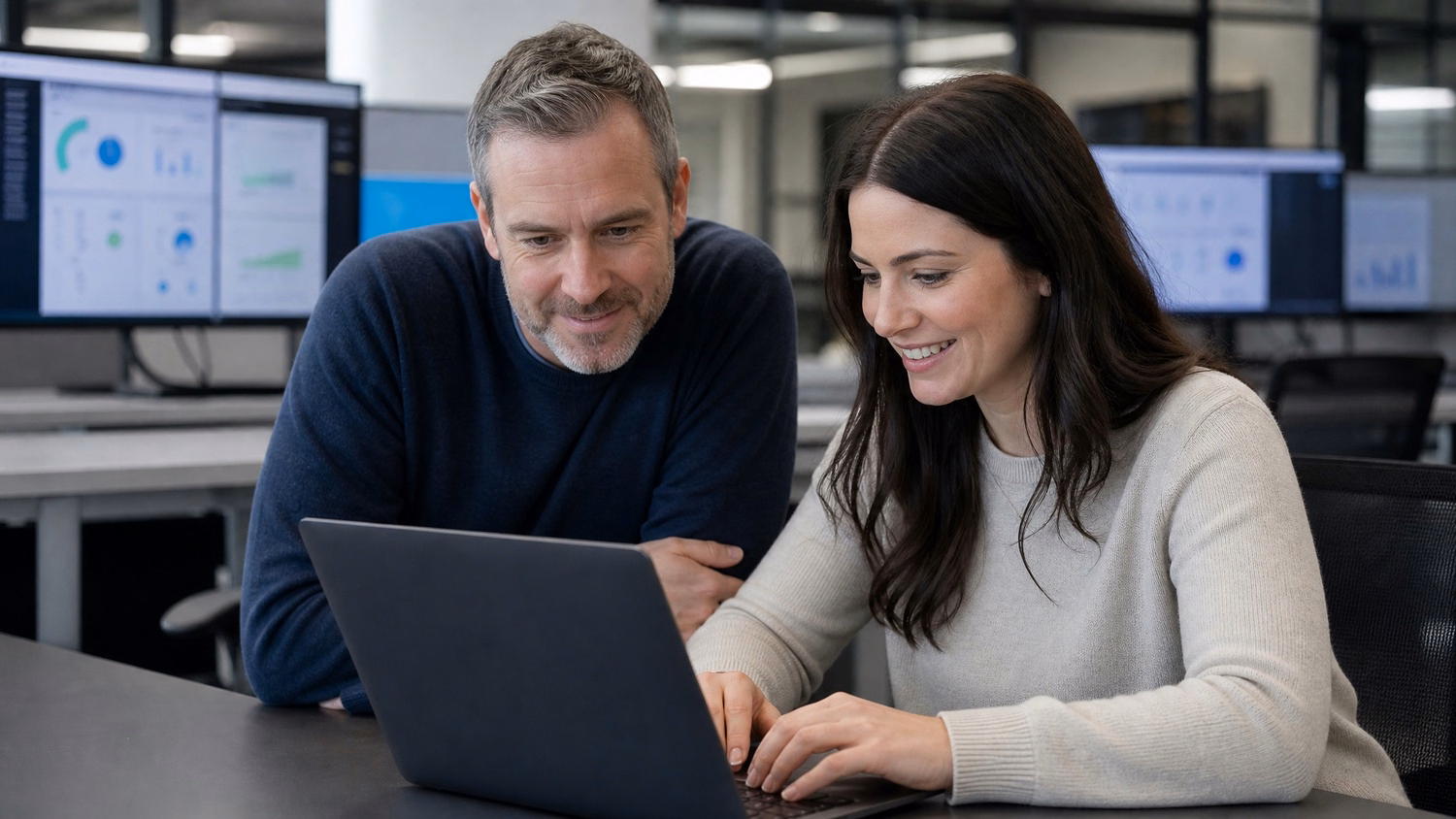 IT team reviewing laptop data together at desk