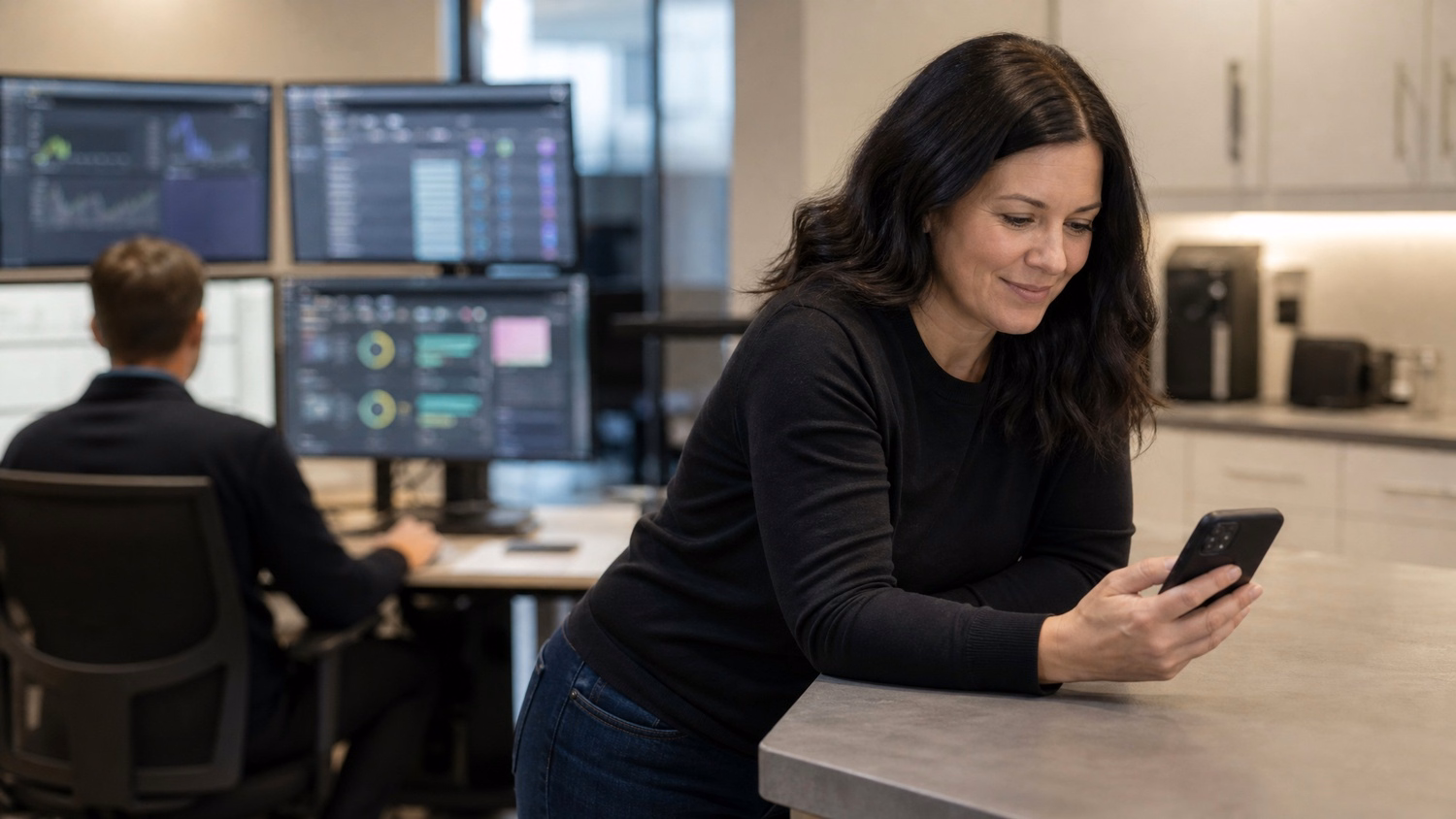 Woman reviews cybersecurity report on phone at counter