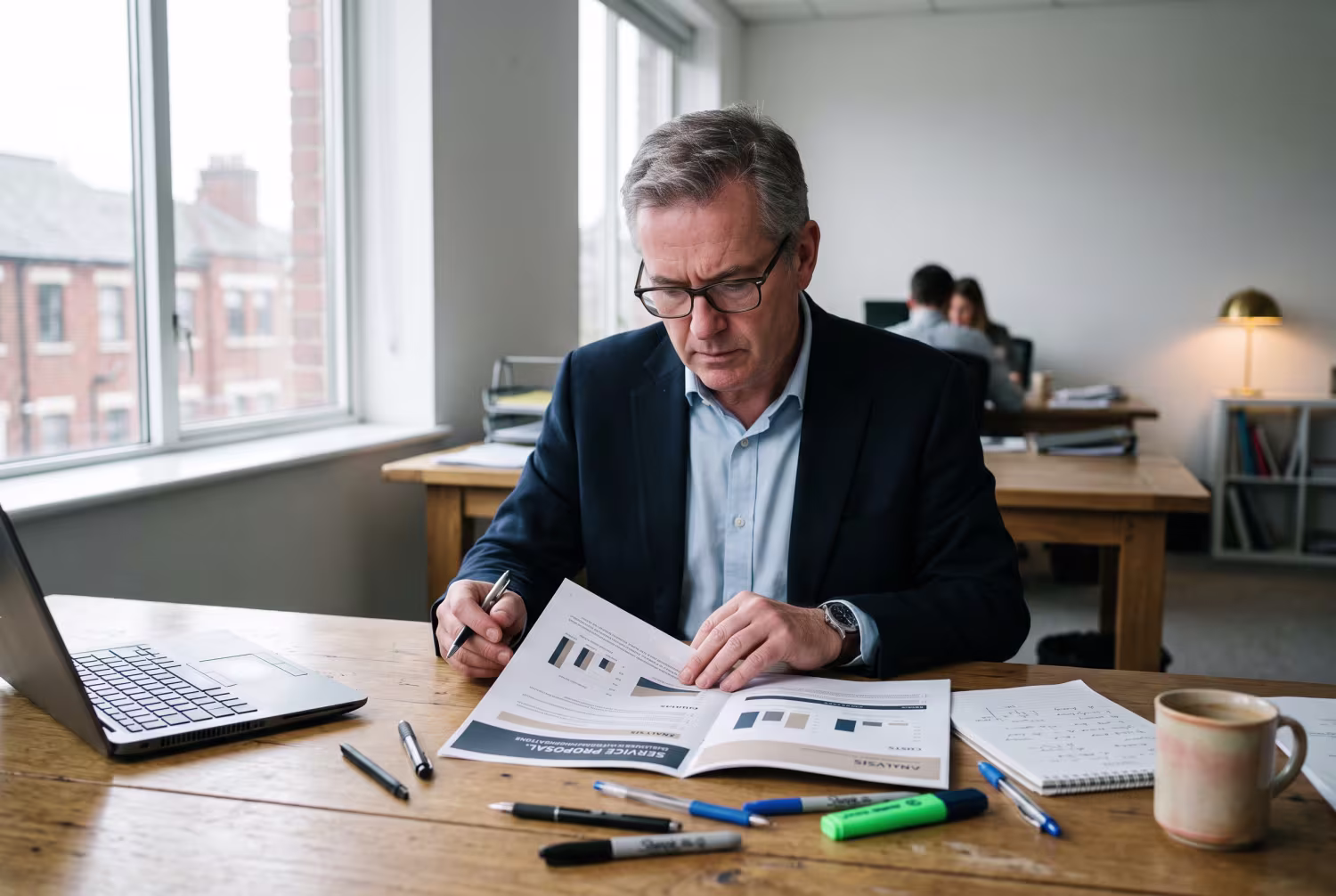 Advisor at desk reviewing service proposal in office