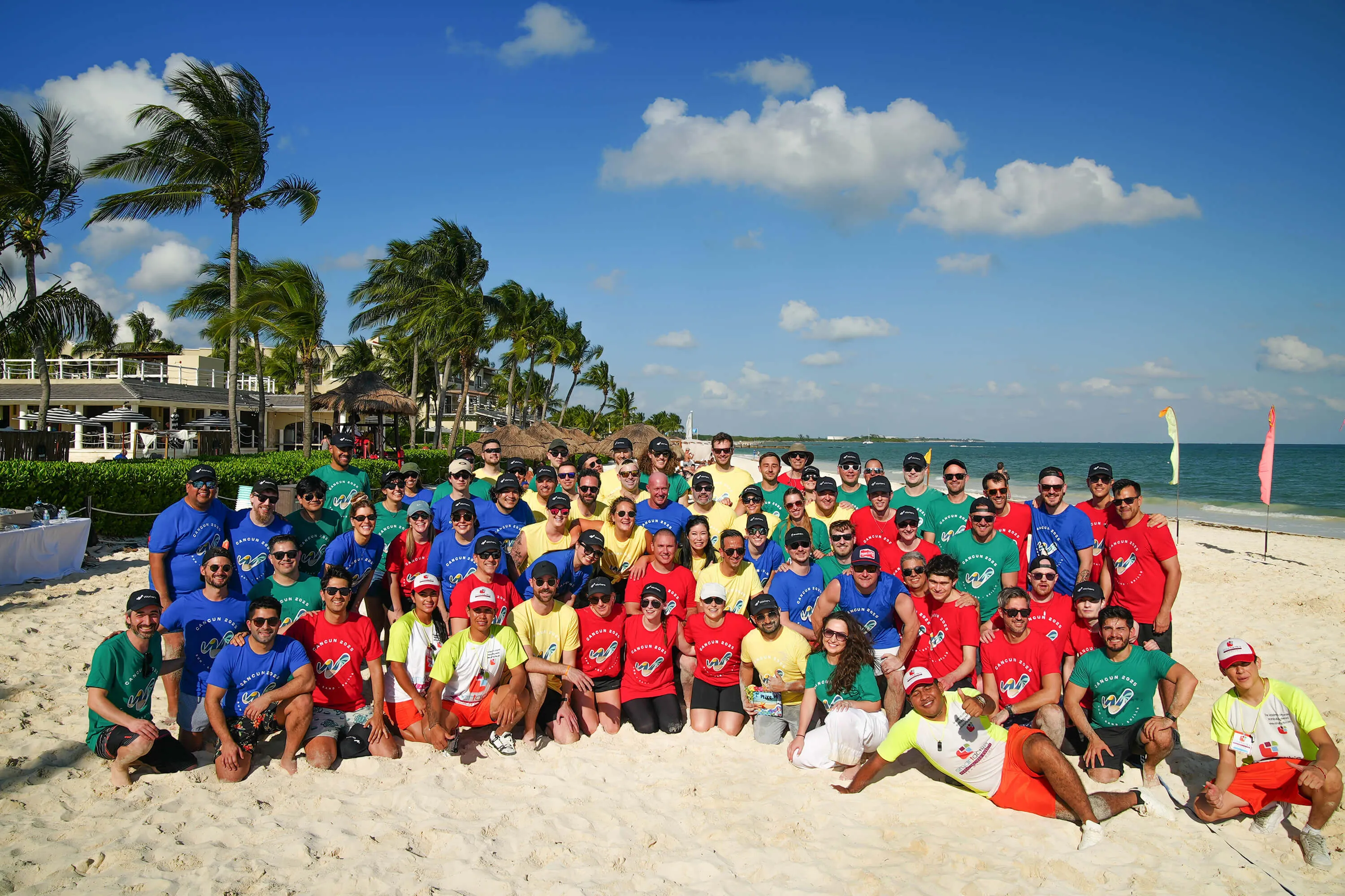 Workera team members posing together on a beach during a company retreat in Cancun