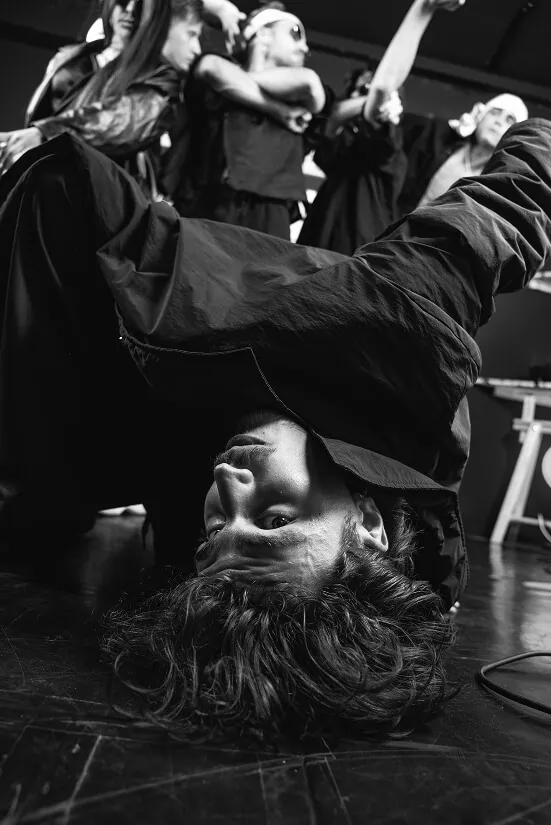 Nace Novak looking at you in an upside down pose.