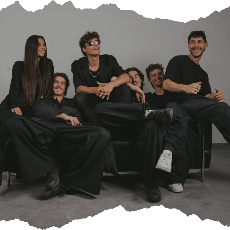 Kuga Studio members and mentors chilling on the couch and laughing.