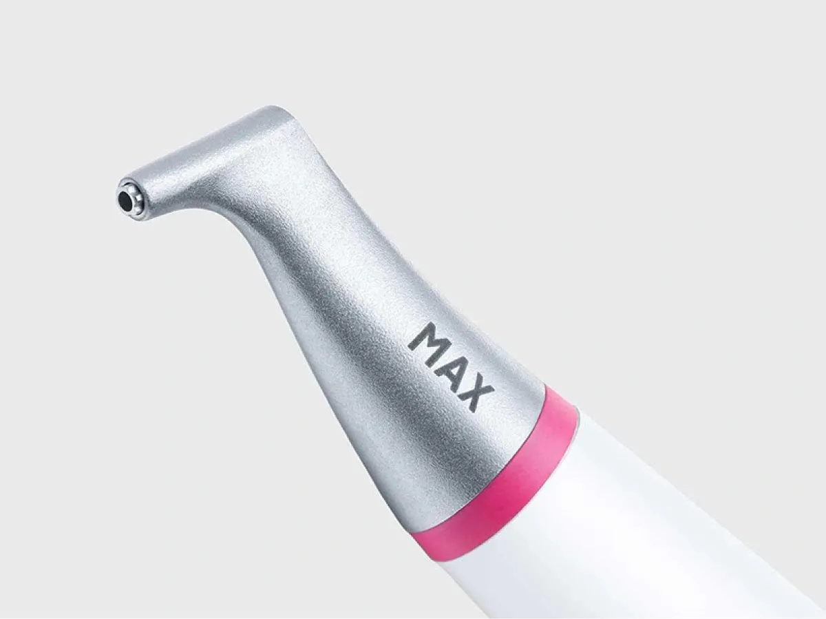 Close-up of a dental handpiece tool with MAX branding and a pink accent.